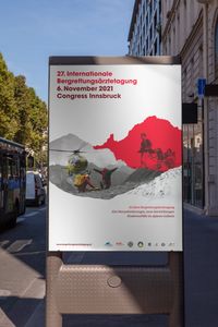 A poster advertising the 27. mountain rescue medical conference in Innsbruck. The key visual shows two pictures framed by overlapping silhouettes of Innsbrucks surrounding mountains. One picture shows two mountain rescue team members, one of them instructing an approaching helicopter. The other picture shows a historic rescue scene. Two people carrying a patient on a special litter with a supporting wheel in the center. The historic image is placed on a vivid red background.
